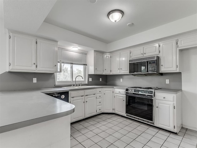 6404 Westway, Oklahoma City, OK 73142 - kitchen featuring range with gas cooktop, black microwave, white cabinetry, and light countertops