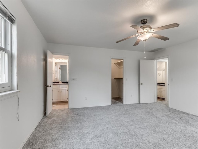 6404 Westway, Oklahoma City, OK 73142 - unfurnished bedroom with light carpet, a walk in closet, and multiple windows