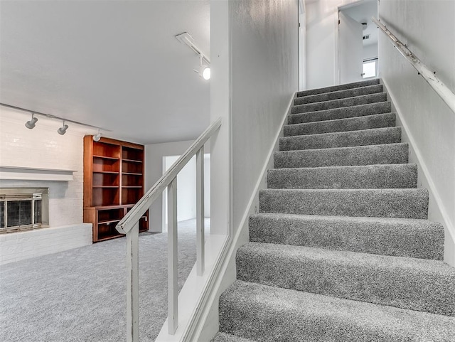 6404 Westway, Oklahoma City, OK 73142 - stairs featuring rail lighting, carpet flooring, a glass covered fireplace, and built in features