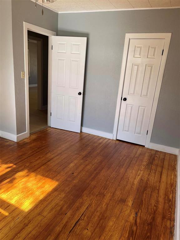 unfurnished bedroom with hardwood / wood-style floors