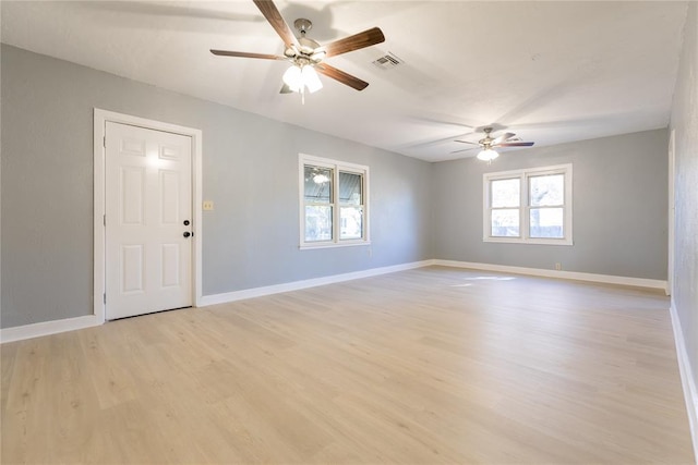 unfurnished room with light wood-type flooring and ceiling fan