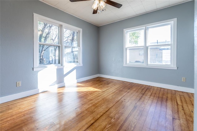 unfurnished room with light wood-type flooring, ceiling fan, and a healthy amount of sunlight