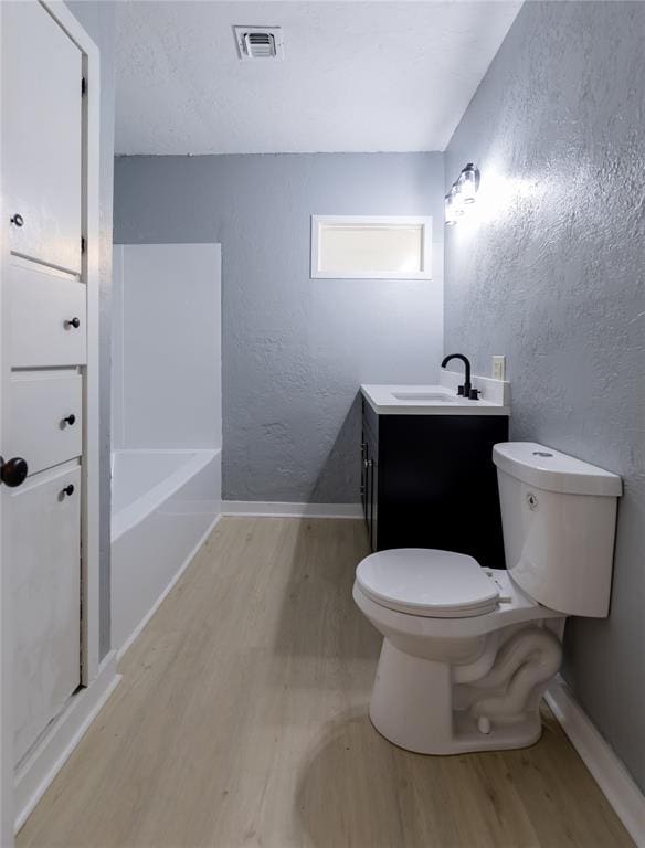 full bathroom with vanity, toilet, wood-type flooring, and plus walk in shower