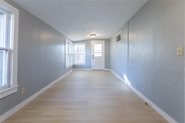 entryway featuring light hardwood / wood-style flooring and lofted ceiling