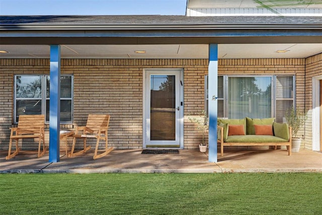 doorway to property with a lawn