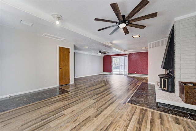 unfurnished living room with a textured ceiling, hardwood / wood-style flooring, a baseboard radiator, and ceiling fan