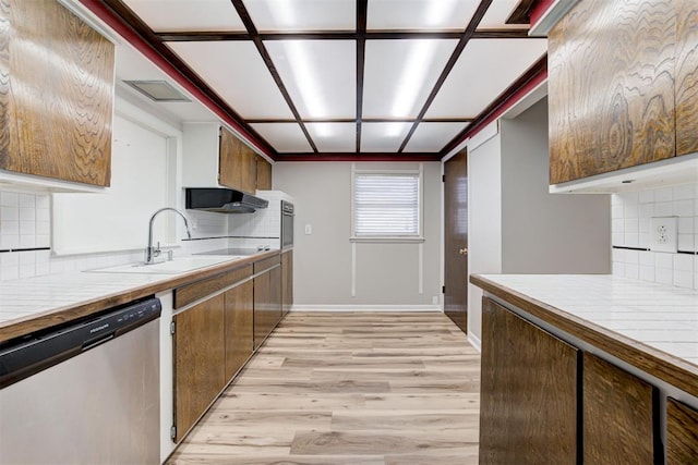 kitchen featuring dishwasher, light wood-type flooring, decorative backsplash, and sink