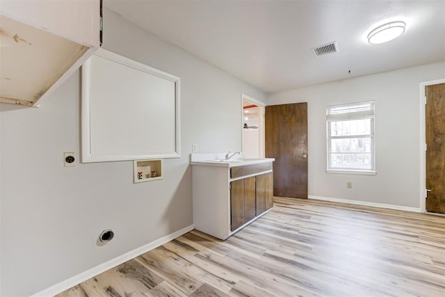 clothes washing area with electric dryer hookup, sink, hookup for a washing machine, and light wood-type flooring