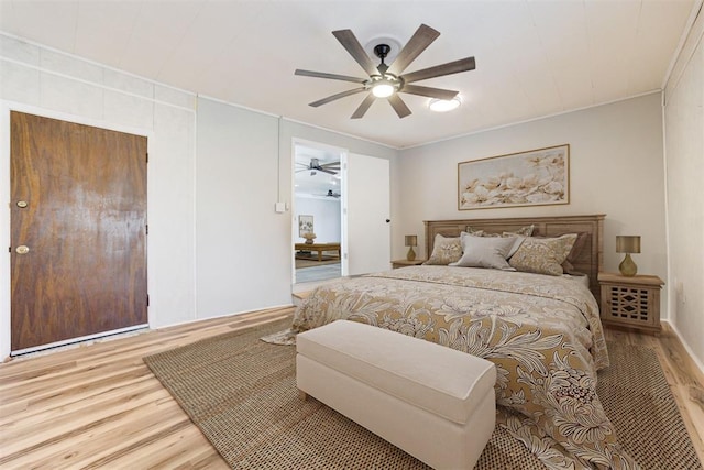 bedroom featuring ceiling fan, wood-type flooring, and ornamental molding