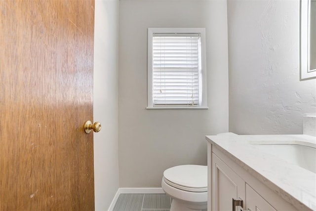 bathroom featuring tile patterned flooring, vanity, and toilet