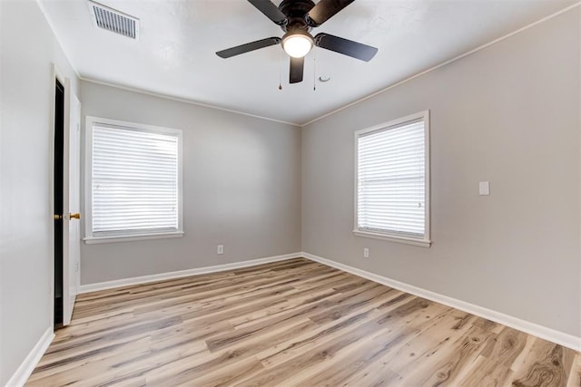 empty room with light hardwood / wood-style flooring, ceiling fan, and ornamental molding