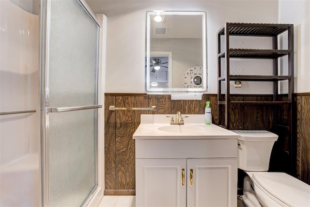 bathroom with ceiling fan, tile patterned floors, an enclosed shower, toilet, and vanity