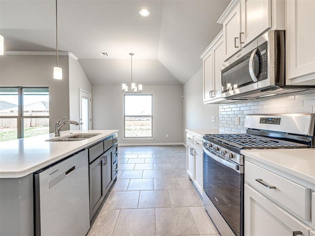 kitchen featuring a wealth of natural light, white cabinetry, sink, and appliances with stainless steel finishes