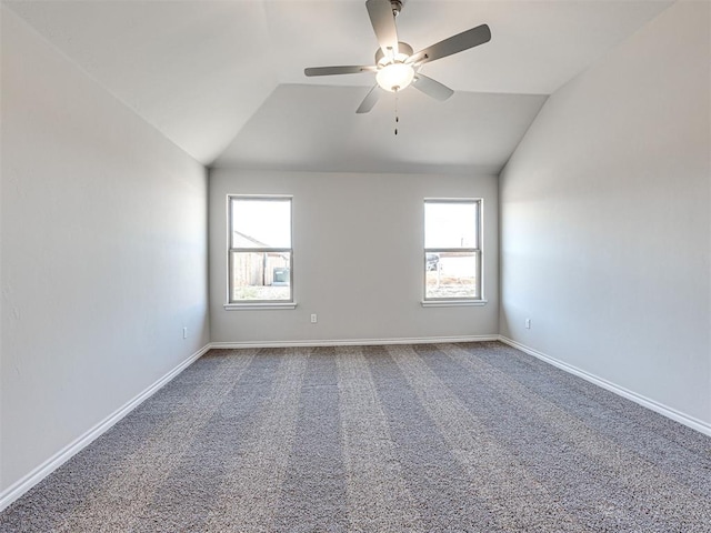 carpeted empty room featuring ceiling fan and vaulted ceiling