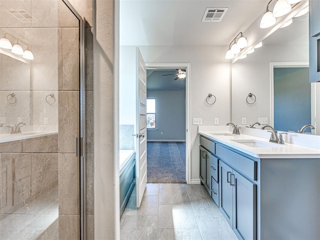 bathroom with tile patterned flooring, vanity, a shower with door, and ceiling fan