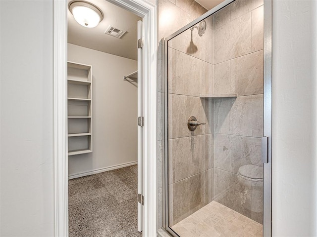 bathroom featuring a shower with door