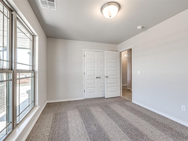 unfurnished bedroom with carpet floors and a closet