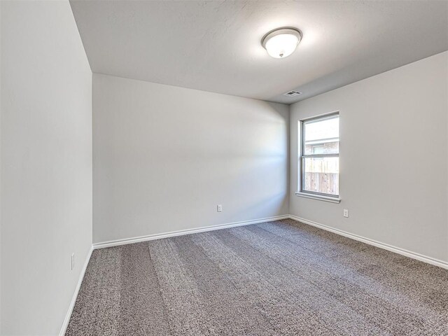 unfurnished room featuring carpet