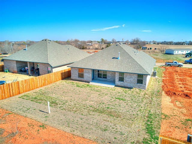 rear view of property featuring a yard and a patio