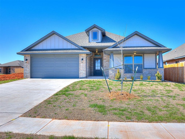 view of front of property with a garage and a front lawn