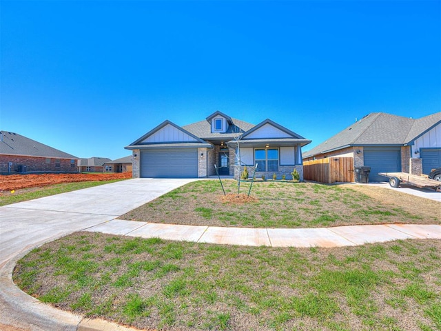 view of front of property featuring a front yard and a garage