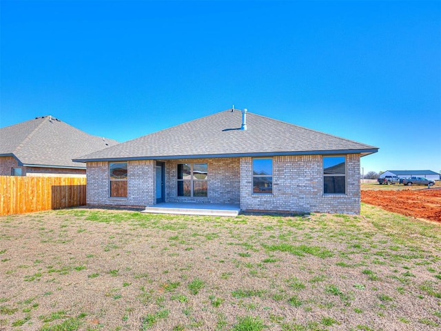 back of property featuring a patio and a lawn