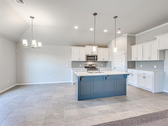 kitchen with a kitchen island with sink, hanging light fixtures, white cabinetry, stainless steel appliances, and a chandelier