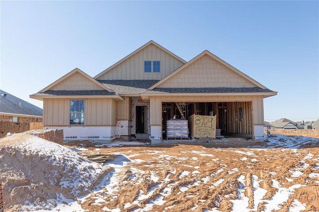 view of front of property featuring a garage, roof with shingles, and board and batten siding