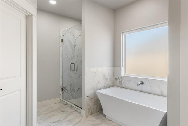 bathroom with shower with separate bathtub