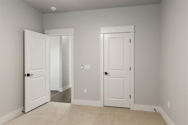 unfurnished bedroom featuring light colored carpet