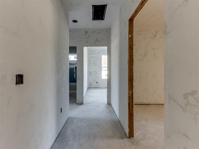 corridor with concrete flooring