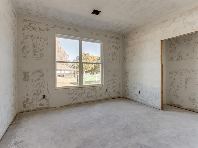 spare room featuring unfinished concrete floors