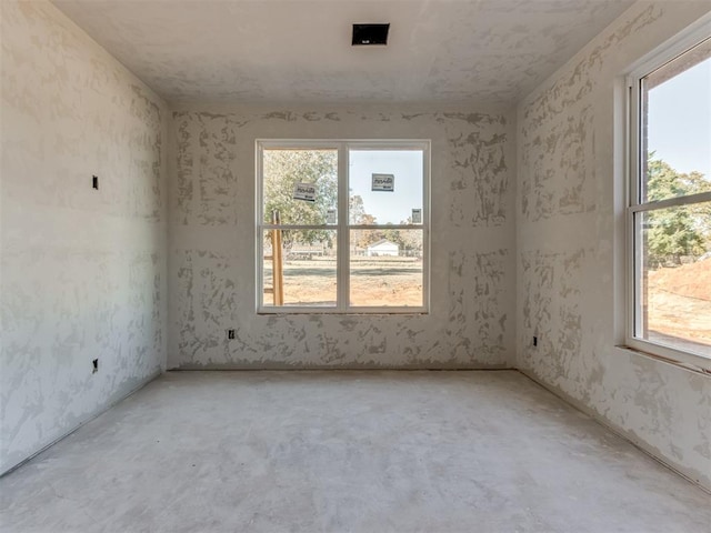 unfurnished room featuring concrete floors