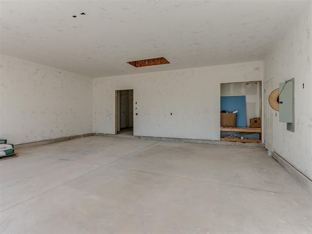 empty room featuring electric panel and concrete floors