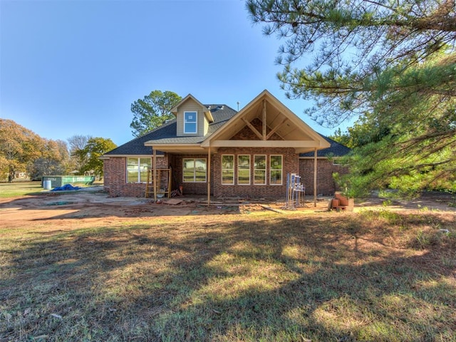 view of front of house with a front yard and brick siding