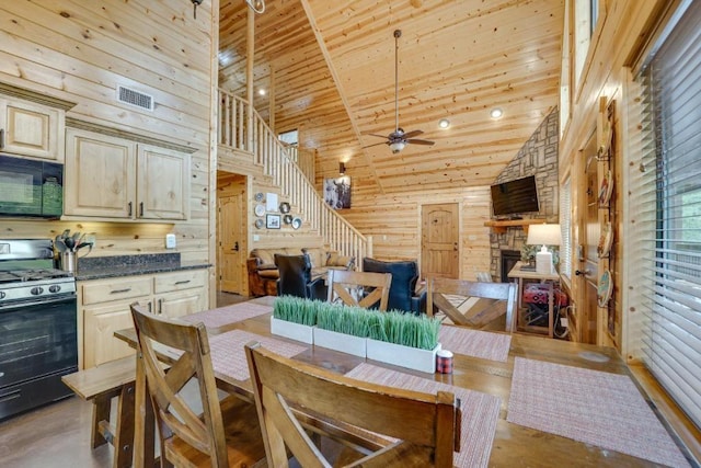 kitchen with ceiling fan, high vaulted ceiling, black appliances, and cream cabinetry