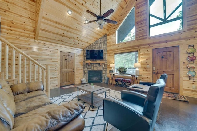 living room with high vaulted ceiling, wooden walls, ceiling fan, a fireplace, and beam ceiling