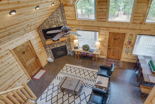 living room with high vaulted ceiling and wooden walls