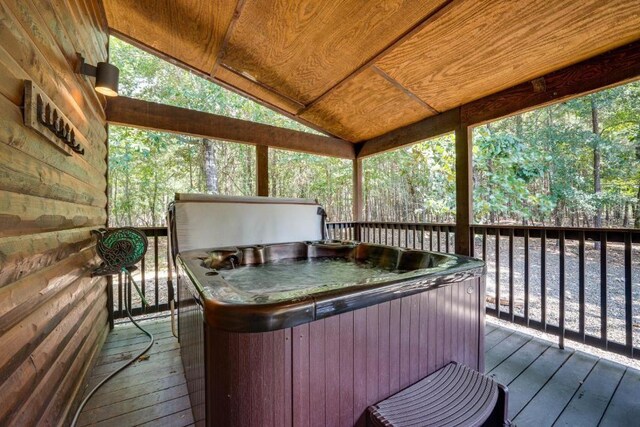 wooden terrace featuring a hot tub