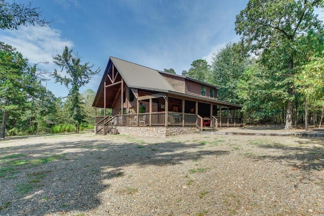 rear view of house featuring a porch