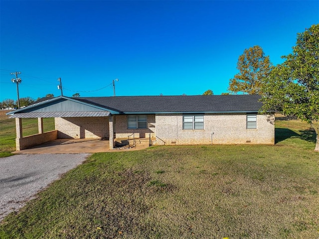 ranch-style home with a front yard and a carport