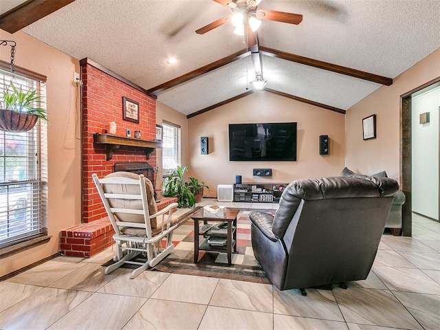 living room featuring ceiling fan, vaulted ceiling with beams, a textured ceiling, a fireplace, and light tile patterned floors