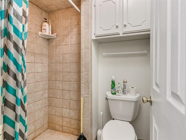 bathroom featuring curtained shower and toilet