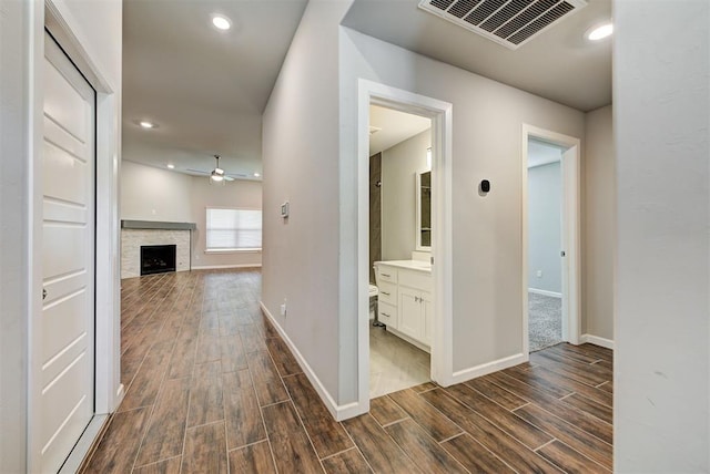 hallway with dark hardwood / wood-style flooring