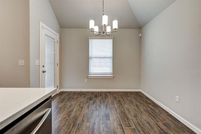 unfurnished dining area featuring dark hardwood / wood-style floors, an inviting chandelier, and lofted ceiling