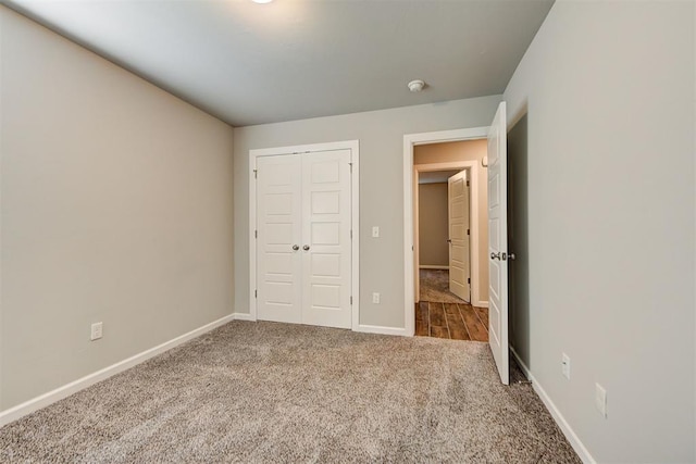 unfurnished bedroom featuring carpet flooring and a closet