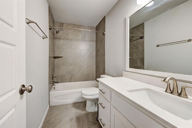 full bathroom featuring vanity, tiled shower / bath combo, and toilet