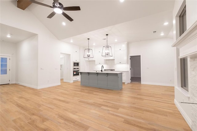 9216 NW 117th St, Yukon, OK 73099 - kitchen with oven, high vaulted ceiling, white cabinetry, recessed lighting, and light countertops