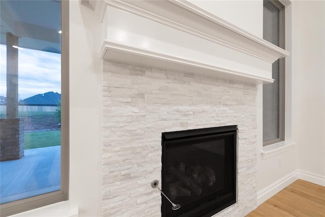 9216 NW 117th St, Yukon, OK 73099 - detailed view of baseboards, wood finished floors, and a fireplace