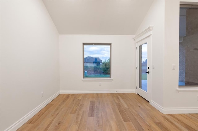 9216 NW 117th St, Yukon, OK 73099 - spare room with vaulted ceiling, light wood finished floors, and baseboards